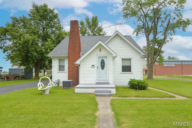307 S S St, Smithton, IL 62285 - bungalow-style home with a front yard, a shingled roof, and a chimney