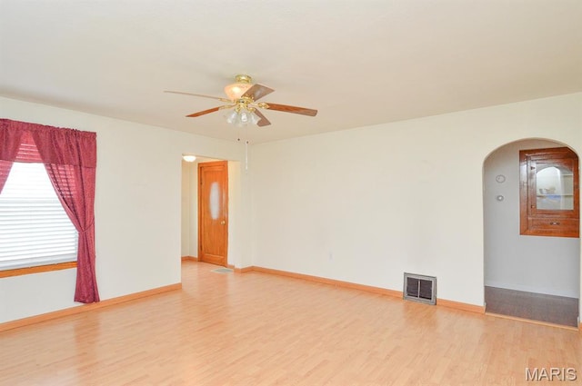 307 S S St, Smithton, IL 62285 - spare room featuring arched walkways, ceiling fan, and light wood-style floors