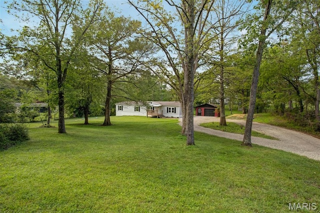 16 Garrett Ln, Defiance, MO 63341 - view of front facade featuring dirt driveway, an outbuilding, and a front yard