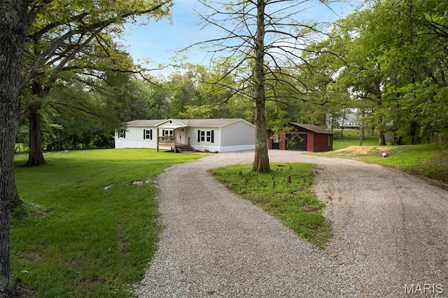 16 Garrett Ln, Defiance, MO 63341 - ranch-style home with curved driveway, an outbuilding, and a front lawn