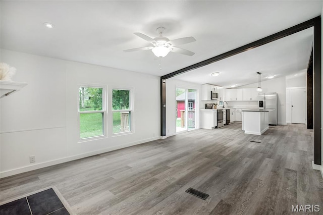 16 Garrett Ln, Defiance, MO 63341 - unfurnished living room featuring a ceiling fan and light wood-style floors