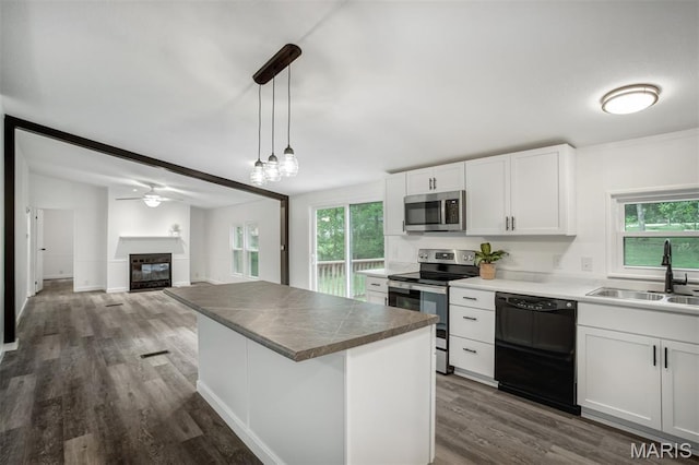 16 Garrett Ln, Defiance, MO 63341 - kitchen featuring stainless steel appliances, dark wood-style flooring, healthy amount of natural light, and white cabinets