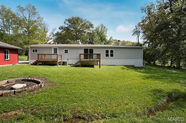 16 Garrett Ln, Defiance, MO 63341 - rear view of property with a fire pit, a wooden deck, and a lawn