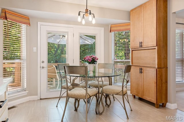 14 Greystoke Ct, Ballwin, MO 63021 - dining space with baseboards and a chandelier