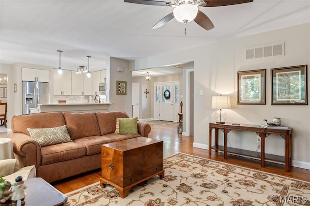 14 Greystoke Ct, Ballwin, MO 63021 - living area with light wood finished floors and a ceiling fan