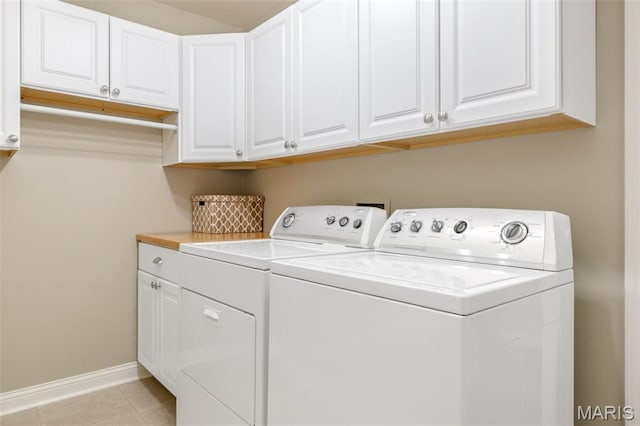 14 Greystoke Ct, Ballwin, MO 63021 - laundry room featuring washing machine and dryer, cabinet space, and light tile patterned floors