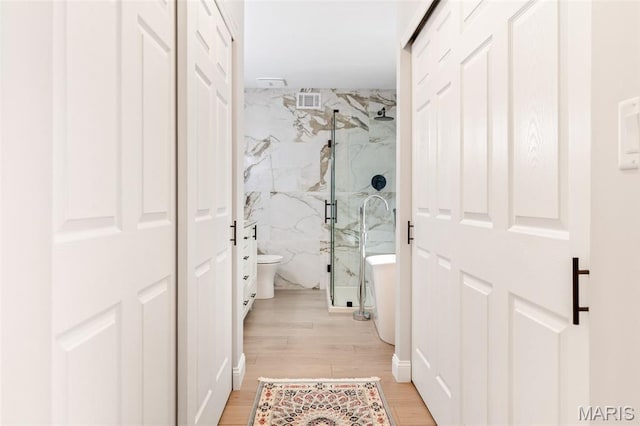 14 Greystoke Ct, Ballwin, MO 63021 - bathroom featuring a marble finish shower, wood finished floors, and a freestanding bath