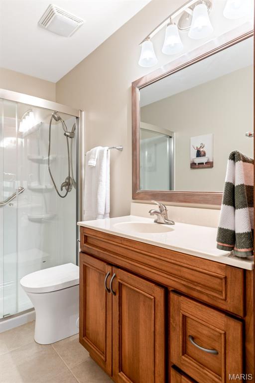 14 Greystoke Ct, Ballwin, MO 63021 - bathroom with vanity, a stall shower, and tile patterned floors