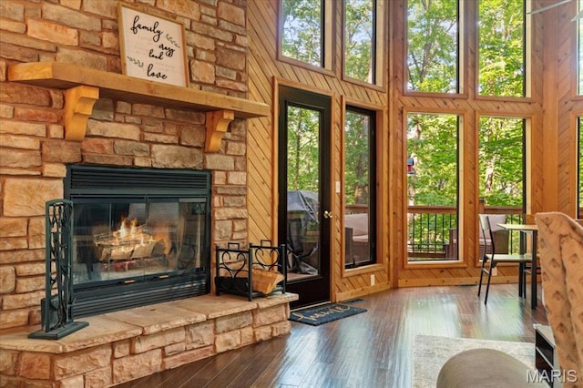 2506 Alpine Woods Dr, Wright City, MO 63390 - unfurnished living room featuring hardwood / wood-style floors, a fireplace, and a towering ceiling