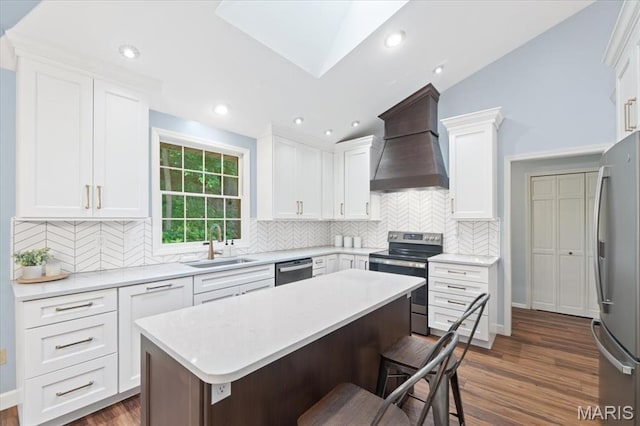 1008 Westrun Dr, Ballwin, MO 63021 - kitchen featuring custom range hood, stainless steel appliances, dark wood-style flooring, a breakfast bar, and white cabinetry