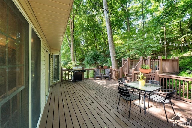 1008 Westrun Dr, Ballwin, MO 63021 - wooden deck featuring outdoor dining space, a grill, and view of wooded area