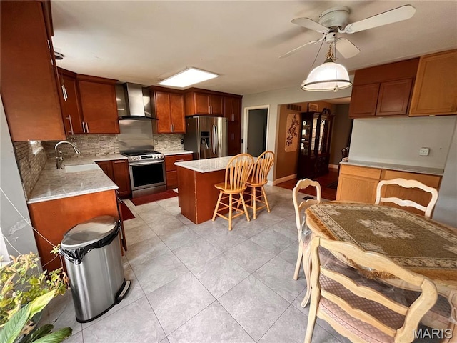 3241 Principia Ave, Saint Charles, MO 63301 - kitchen with appliances with stainless steel finishes, wall chimney range hood, tasteful backsplash, a kitchen island, and a breakfast bar area