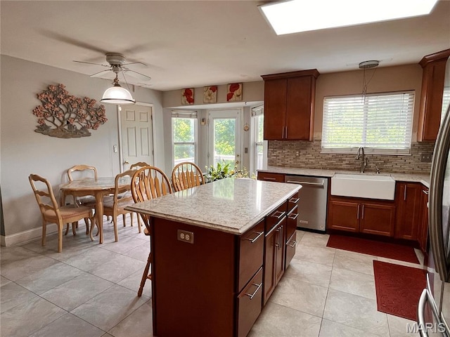 3241 Principia Ave, Saint Charles, MO 63301 - kitchen featuring dishwasher, decorative backsplash, light tile patterned floors, ceiling fan, and a kitchen island