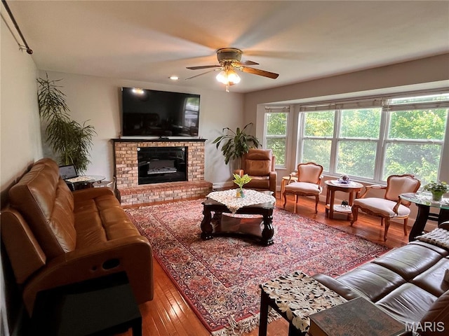 3241 Principia Ave, Saint Charles, MO 63301 - living area with wood finished floors, a ceiling fan, a brick fireplace, and recessed lighting