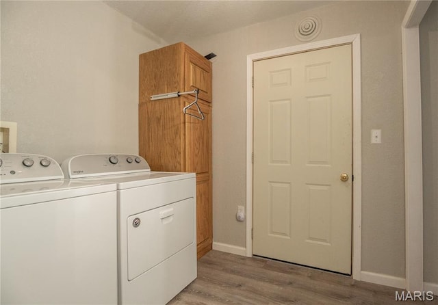 116 Buttry Ln, Wappapello, MO 63966 - laundry area with washing machine and dryer, light wood-type flooring, and cabinet space