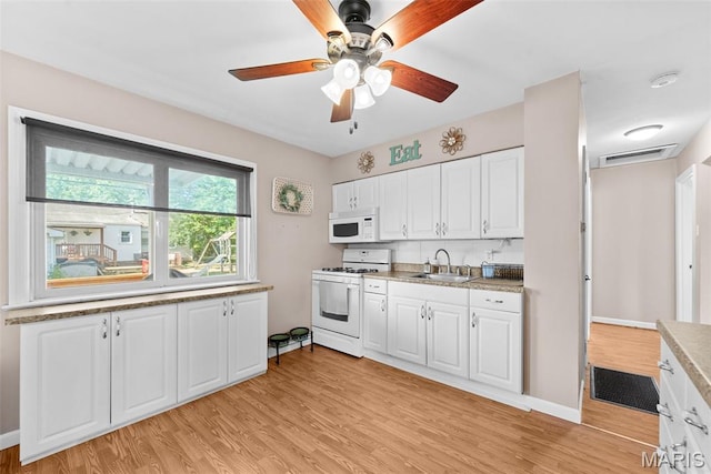 10256 Saint Dennis Ln, Saint Ann, MO 63074 - kitchen with white appliances, light wood-style floors, and white cabinets