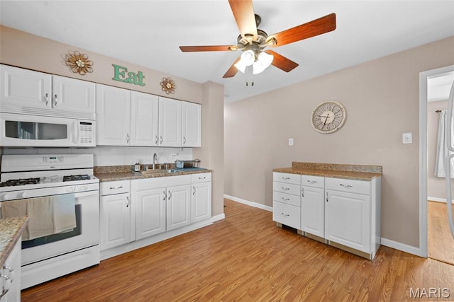 10256 Saint Dennis Ln, Saint Ann, MO 63074 - kitchen with white appliances, light wood-style flooring, a ceiling fan, and white cabinets