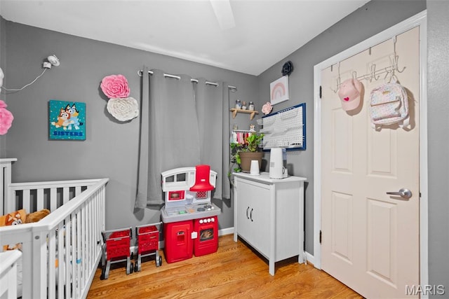 10256 Saint Dennis Ln, Saint Ann, MO 63074 - bedroom with wood finished floors, a crib, and a ceiling fan