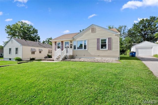 10256 Saint Dennis Ln, Saint Ann, MO 63074 - ranch-style house with a detached garage, a front yard, an outbuilding, and asphalt driveway