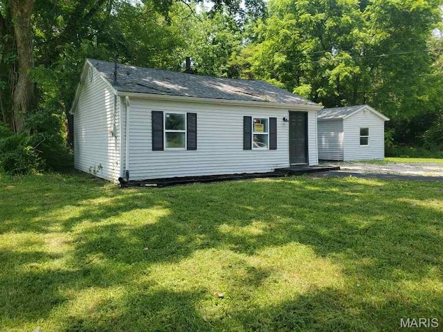2350 Lorraine Dr E, St Louis, IL 62206 - view of front of home featuring a front lawn, an outdoor structure, and roof with shingles
