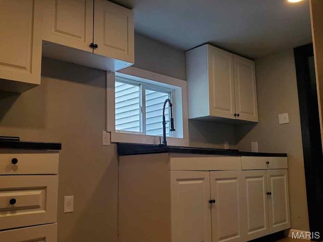 2350 Lorraine Dr E, St Louis, IL 62206 - kitchen with white cabinetry and dark countertops