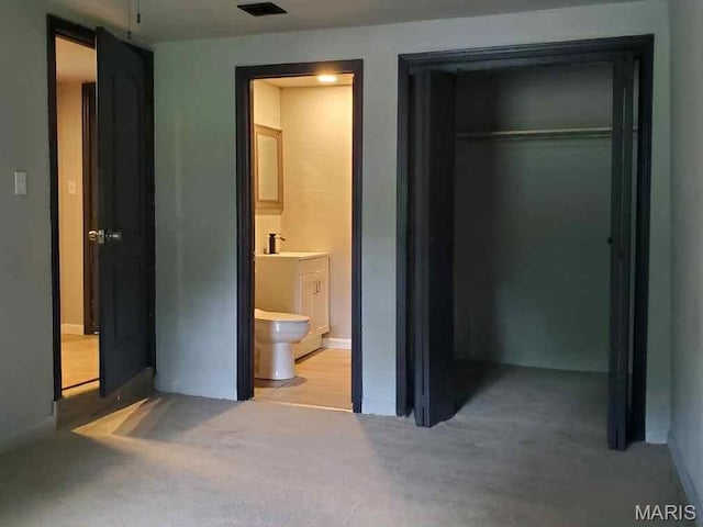 2350 Lorraine Dr E, St Louis, IL 62206 - unfurnished bedroom featuring light colored carpet, a closet, and ensuite bathroom