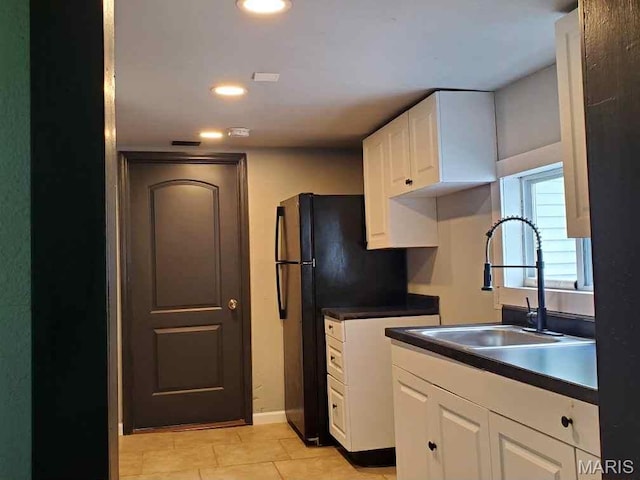 2350 Lorraine Dr E, St Louis, IL 62206 - kitchen featuring white cabinetry, dark countertops, freestanding refrigerator, light tile patterned floors, and recessed lighting
