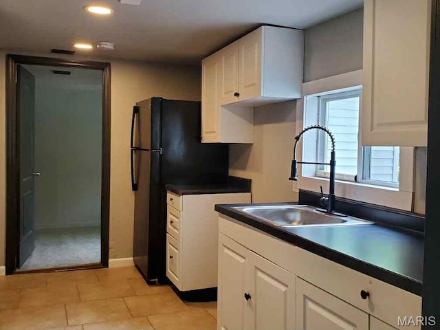 2350 Lorraine Dr E, St Louis, IL 62206 - kitchen featuring white cabinets, dark countertops, recessed lighting, light tile patterned floors, and freestanding refrigerator