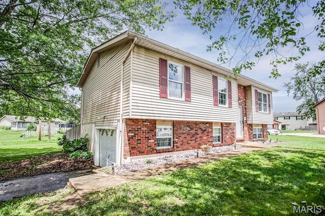 7800 Chuck Ct, Godfrey, IL 62035 - view of front of home with a garage, driveway, and a front yard