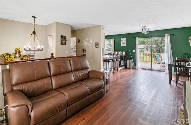7800 Chuck Ct, Godfrey, IL 62035 - living room with a chandelier, wood finished floors, and a textured ceiling