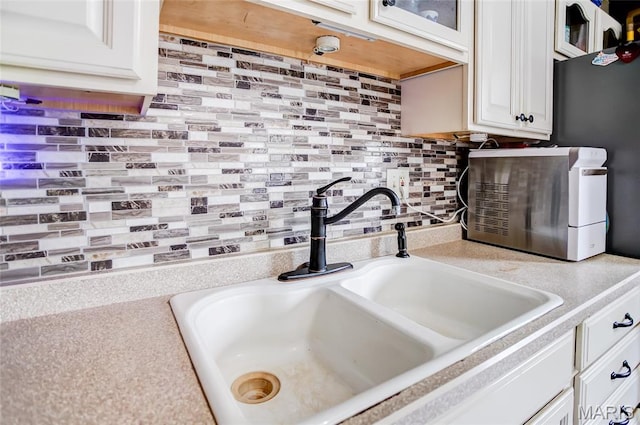 7800 Chuck Ct, Godfrey, IL 62035 - kitchen view of light countertops, decorative backsplash, glass insert cabinets, and white cabinets