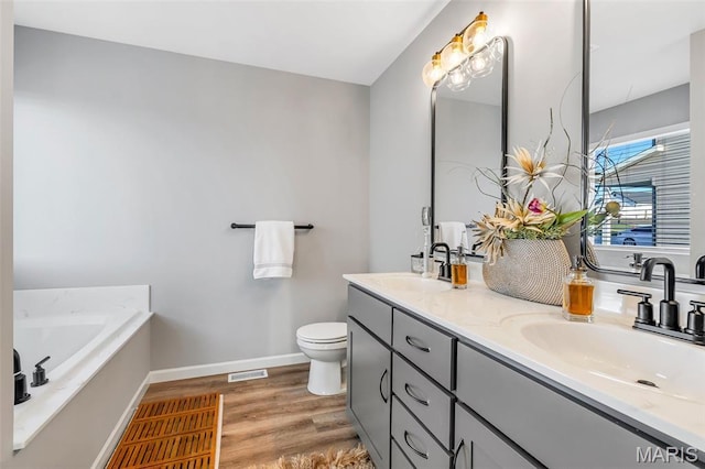 1896 W Main St, Festus, MO 63028 - full bathroom with double vanity, wood finished floors, and a garden tub