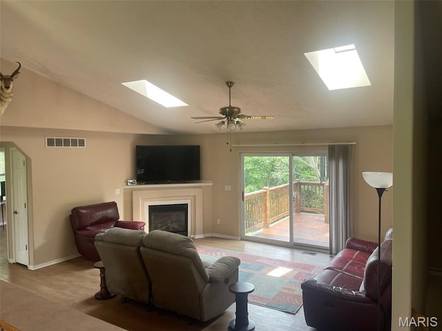 17035 Lanes End, Dixon, MO 65459 - living area featuring a skylight, a glass covered fireplace, lofted ceiling, and ceiling fan