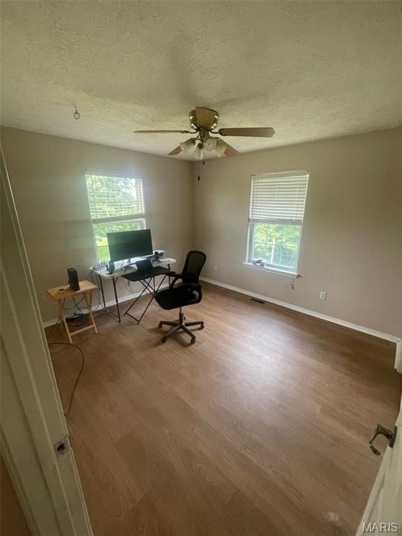 17035 Lanes End, Dixon, MO 65459 - home office with wood finished floors, a textured ceiling, and a ceiling fan