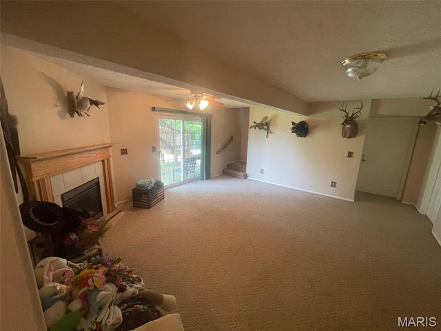 17035 Lanes End, Dixon, MO 65459 - carpeted living room with a tiled fireplace, a ceiling fan, stairs, and a textured ceiling