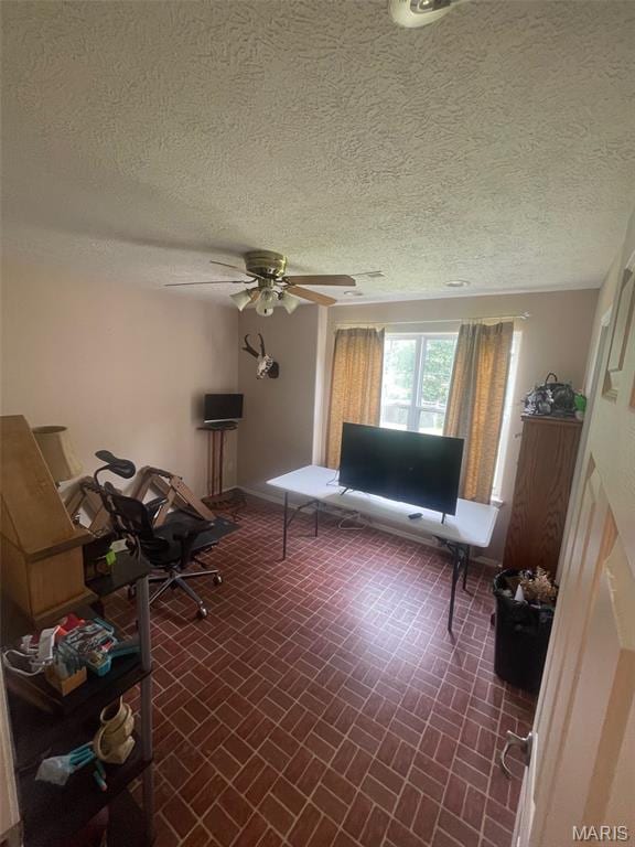 17035 Lanes End, Dixon, MO 65459 - living area featuring brick patterned floors, a ceiling fan, and a textured ceiling