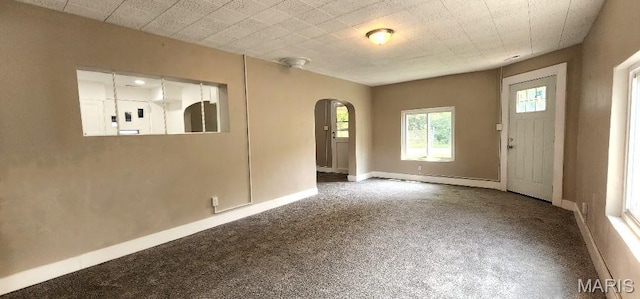 115 N 5th St, De Soto, MO 63020 - foyer entrance featuring arched walkways and carpet flooring