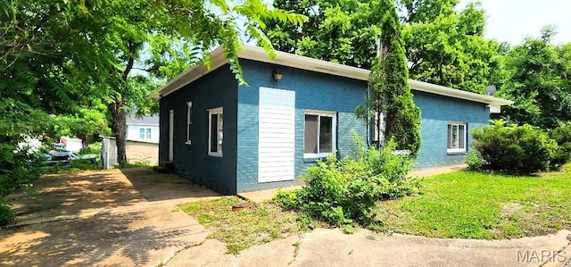 115 N 5th St, De Soto, MO 63020 - view of home's exterior featuring brick siding