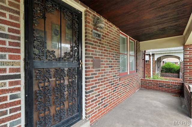 887 Wall St, Saint Louis, MO 63147 - entrance to property featuring a porch and brick siding