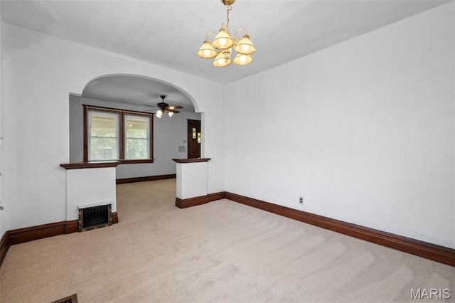 887 Wall St, Saint Louis, MO 63147 - unfurnished living room with carpet flooring, arched walkways, a chandelier, a ceiling fan, and a fireplace with flush hearth