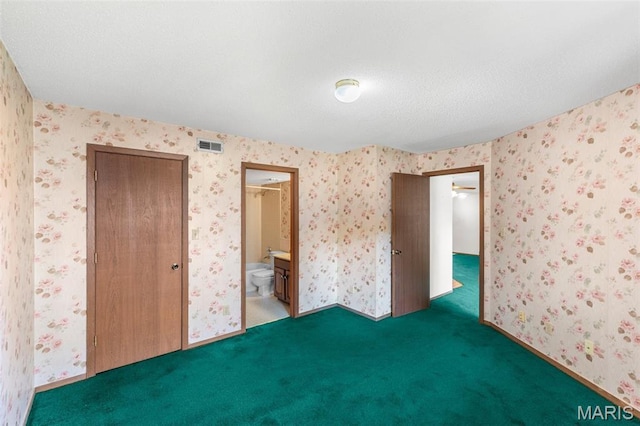 1514 Summer Run Dr Unit 208, Florissant, MO 63033 - unfurnished bedroom featuring carpet, connected bathroom, wallpapered walls, and a closet