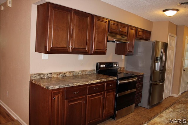17576 Rigdon St, Kennett, MO 63857 - kitchen featuring appliances with stainless steel finishes, under cabinet range hood, a textured ceiling, and dark countertops