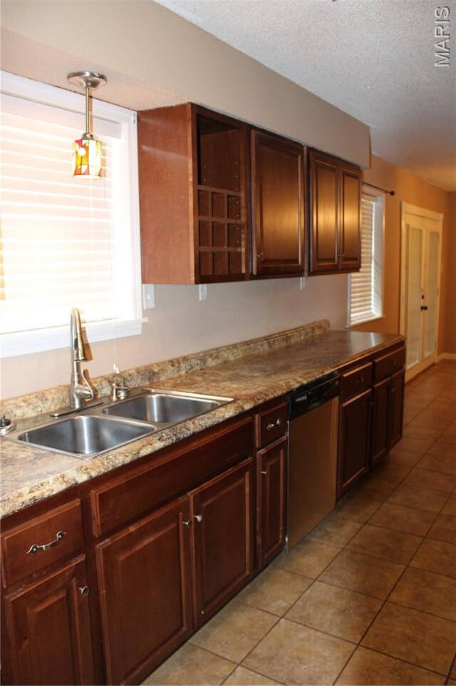 17576 Rigdon St, Kennett, MO 63857 - kitchen with dishwasher, light tile patterned floors, a textured ceiling, light countertops, and decorative light fixtures