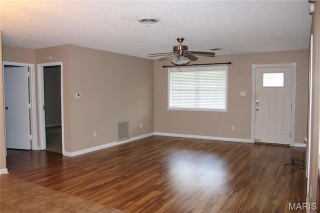 17576 Rigdon St, Kennett, MO 63857 - unfurnished living room with a ceiling fan, a textured ceiling, and wood finished floors