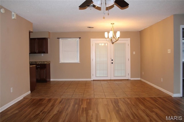 17576 Rigdon St, Kennett, MO 63857 - entrance foyer with a ceiling fan, dark wood finished floors, a chandelier, french doors, and a textured ceiling