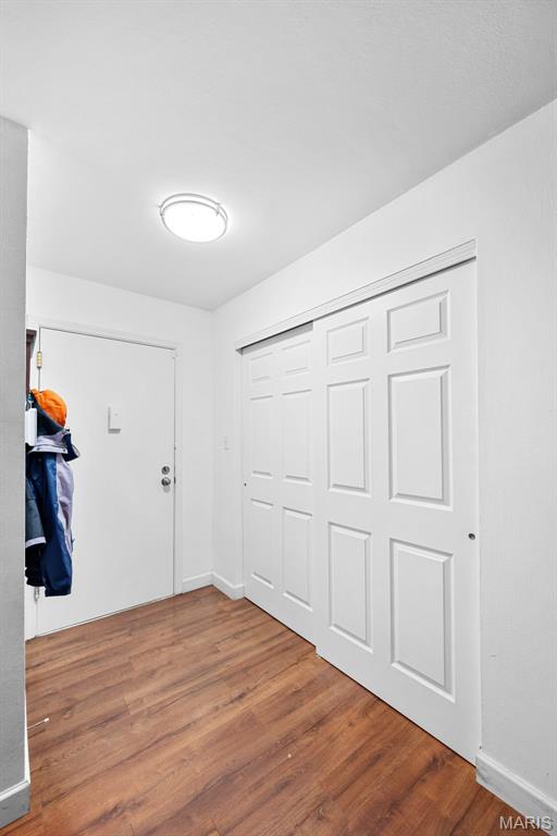 1400 Heritage Lndg Unit 109, Saint Charles, MO 63303 - foyer with wood finished floors and baseboards