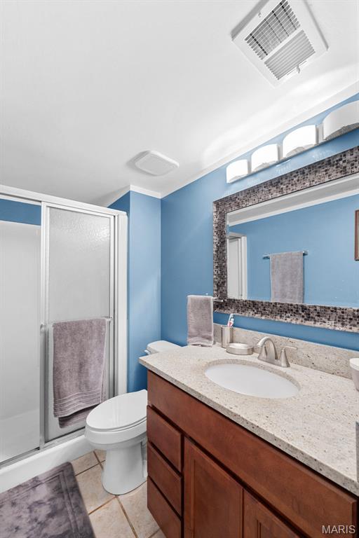 1400 Heritage Lndg Unit 109, Saint Charles, MO 63303 - full bath featuring vanity, a stall shower, and tile patterned floors