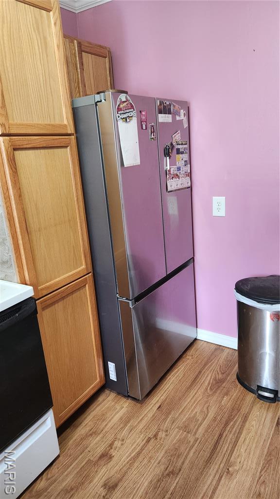 800 N Hickory St, Salem, MO 65560 - kitchen featuring freestanding refrigerator, light wood-style flooring, and stove