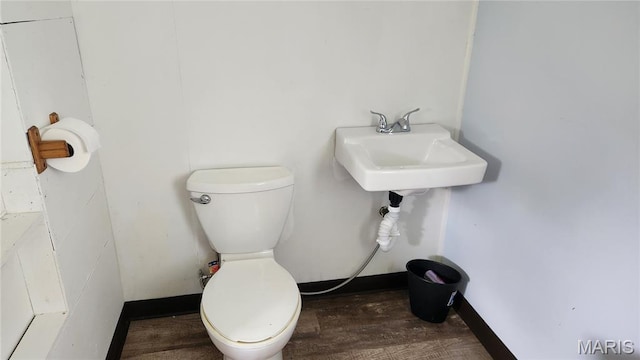 800 N Hickory St, Salem, MO 65560 - bathroom featuring toilet and wood finished floors