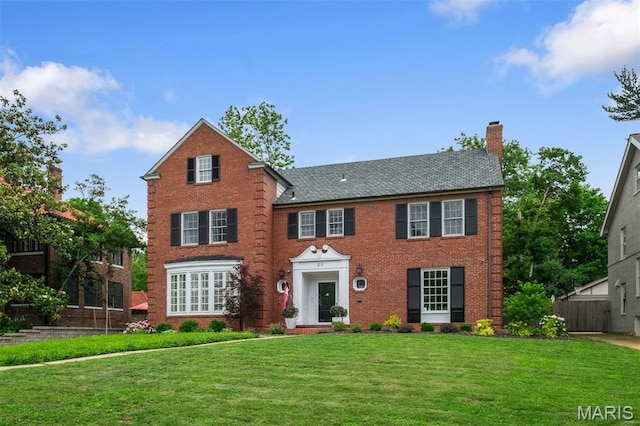 20 Ridgemoor Dr, Clayton, MO 63105 - georgian-style home with a chimney and brick siding